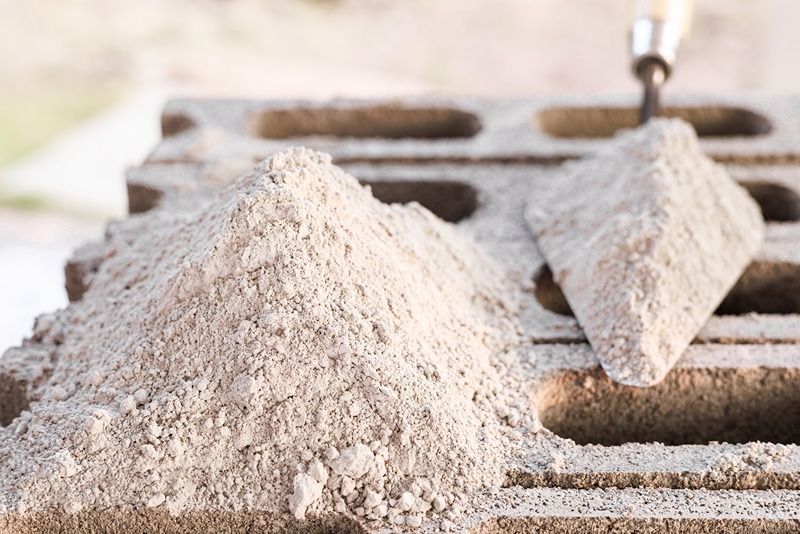 What are the chemical properties of different types of cement and how do they affect construction?-image